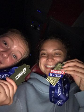 Sage Fernandez, right, with her medal on the way home from a race.