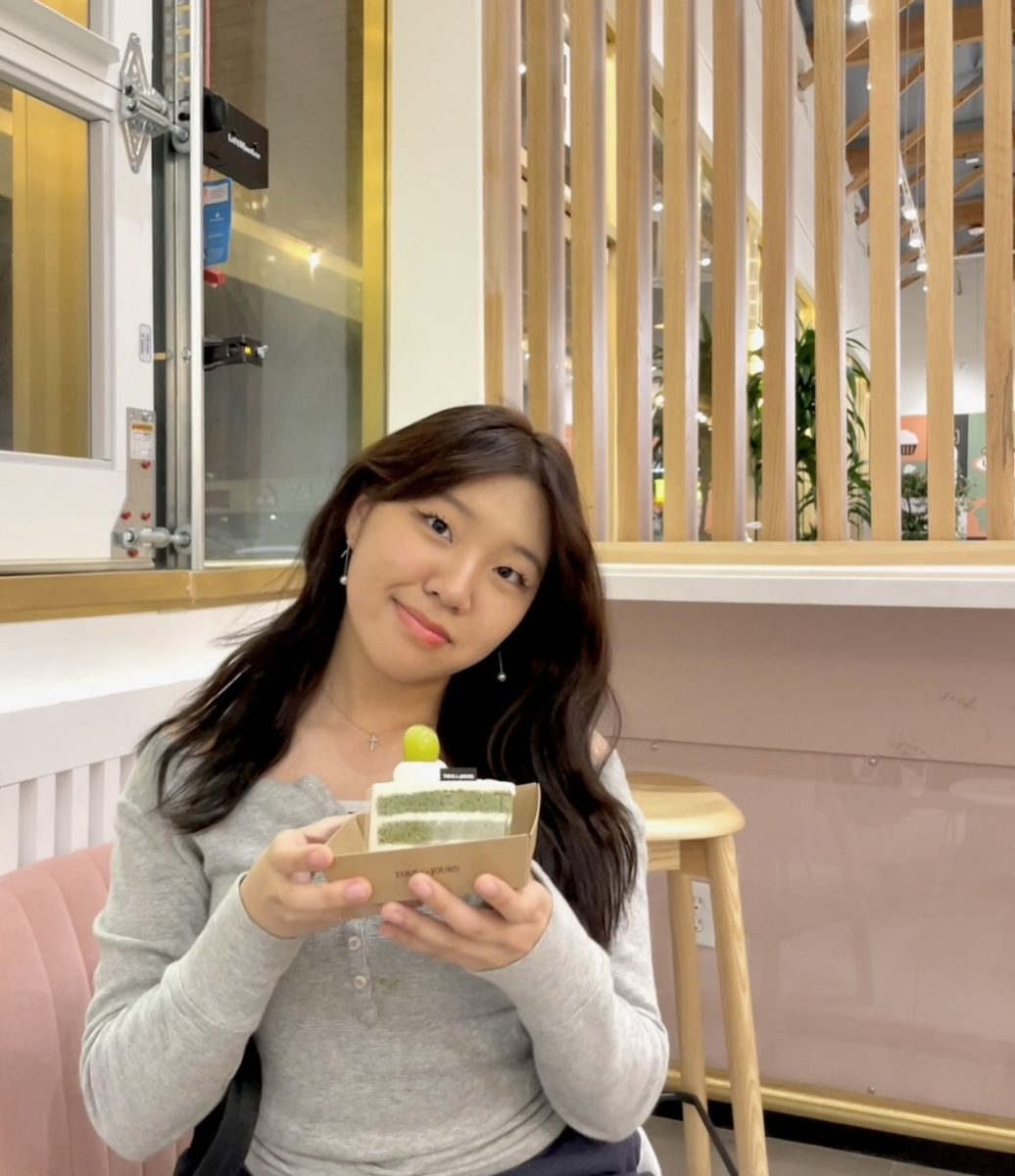 Isabelle Kim, seated at a cafe, showcasing her order after discussing her future and the importance behind her relationships. 