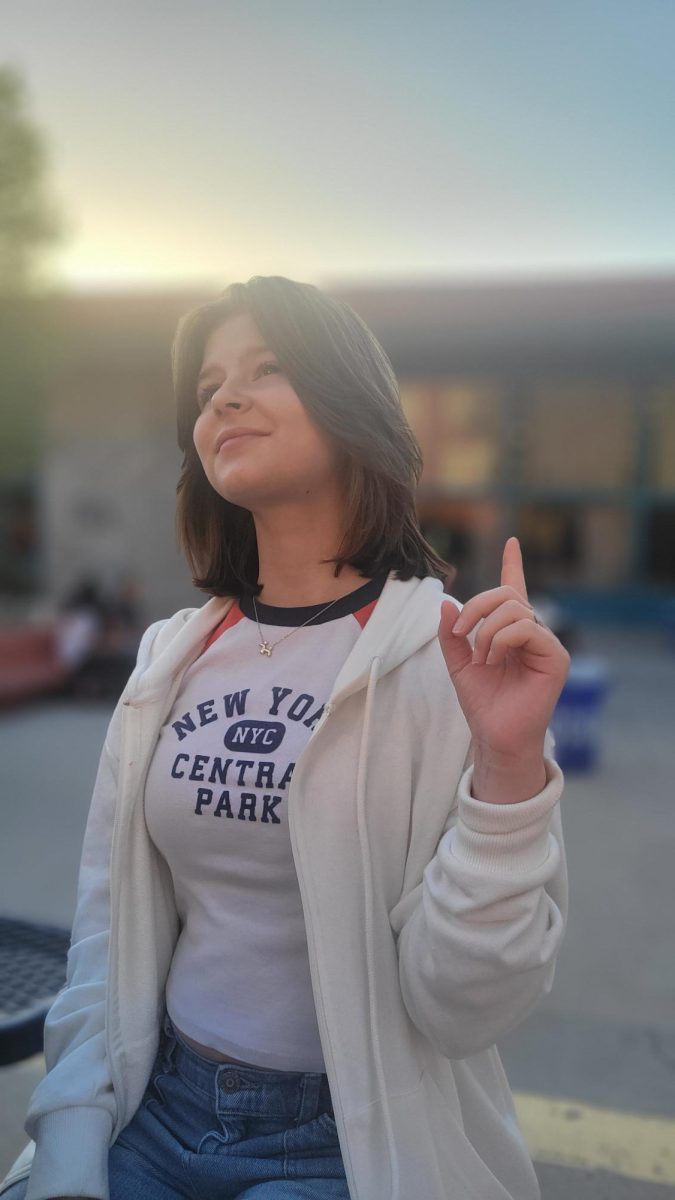 Audrey Stroud looks up and points her finger as she describes the fun activities in her major class.
