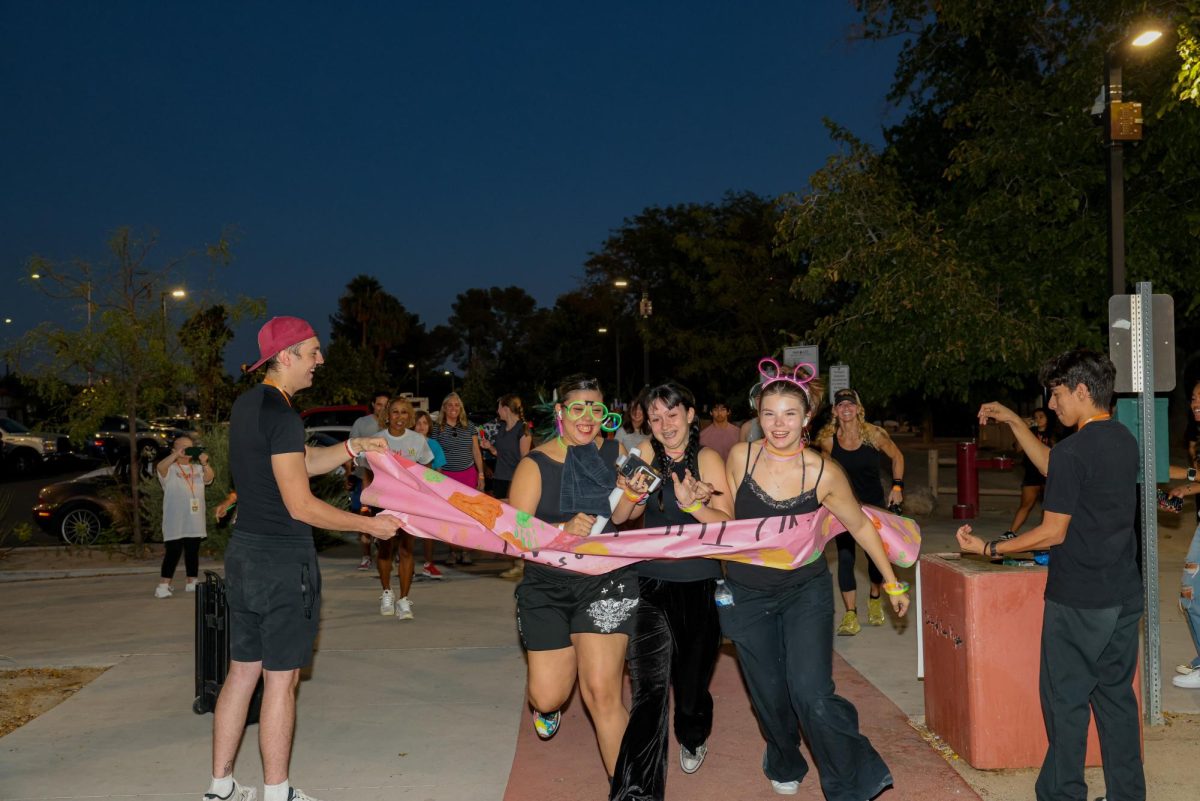 Participants of the Behind the Lens Glow Run start the race. Photo by Nate Guerrero. 