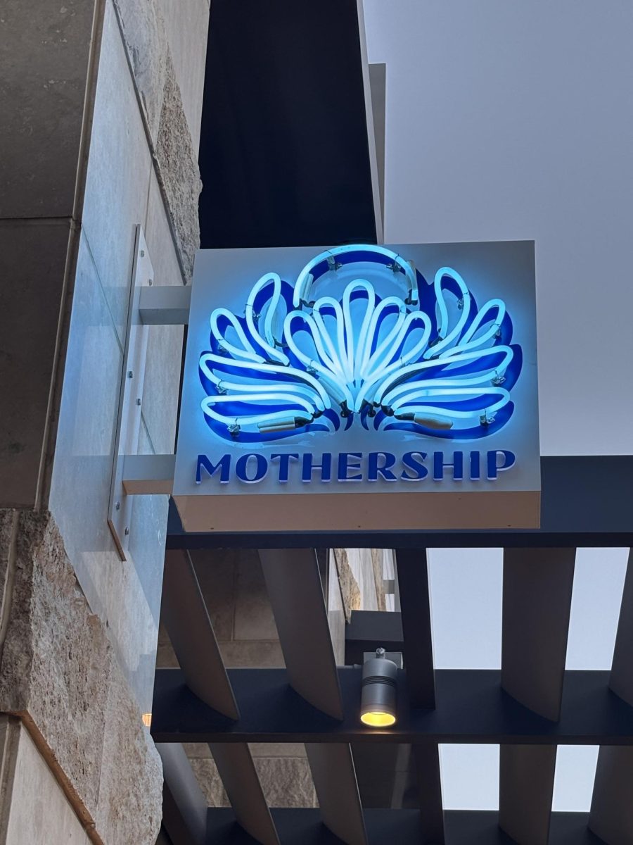 A neon sign featuring Mothership’s logo.
