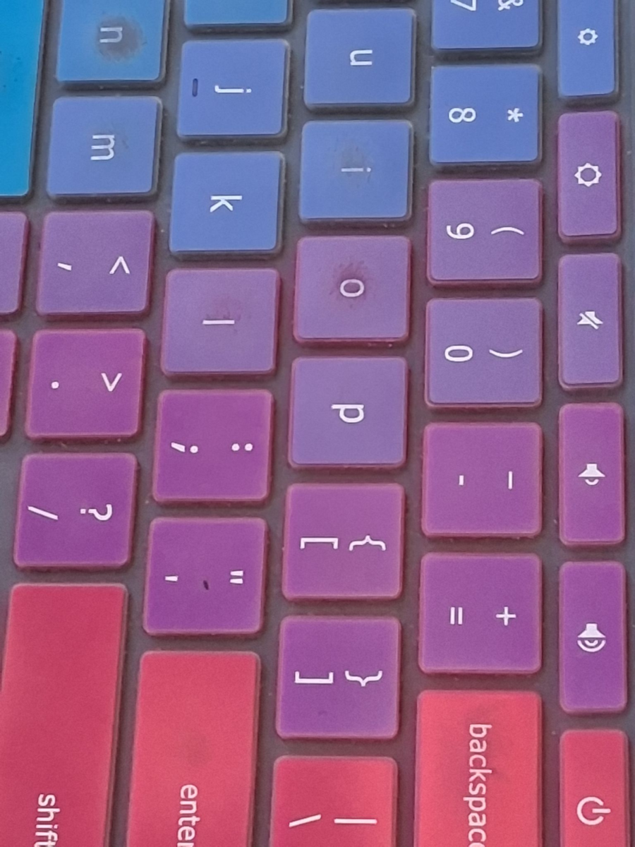 A students keyboard with keys in multiple colors, Including purple.